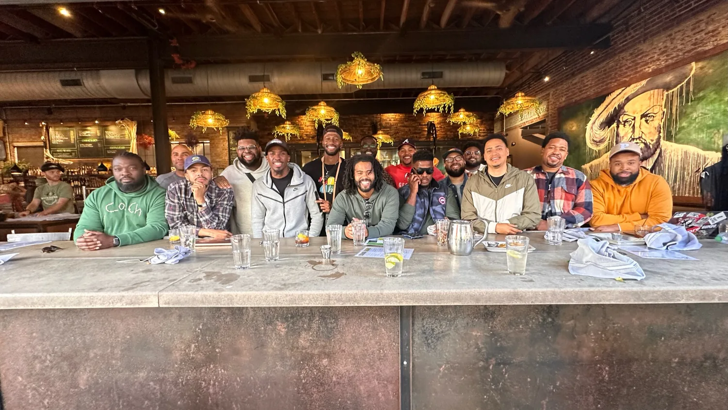 The men of The Healing lined up along one long table, mid-meal and mid-conversation
