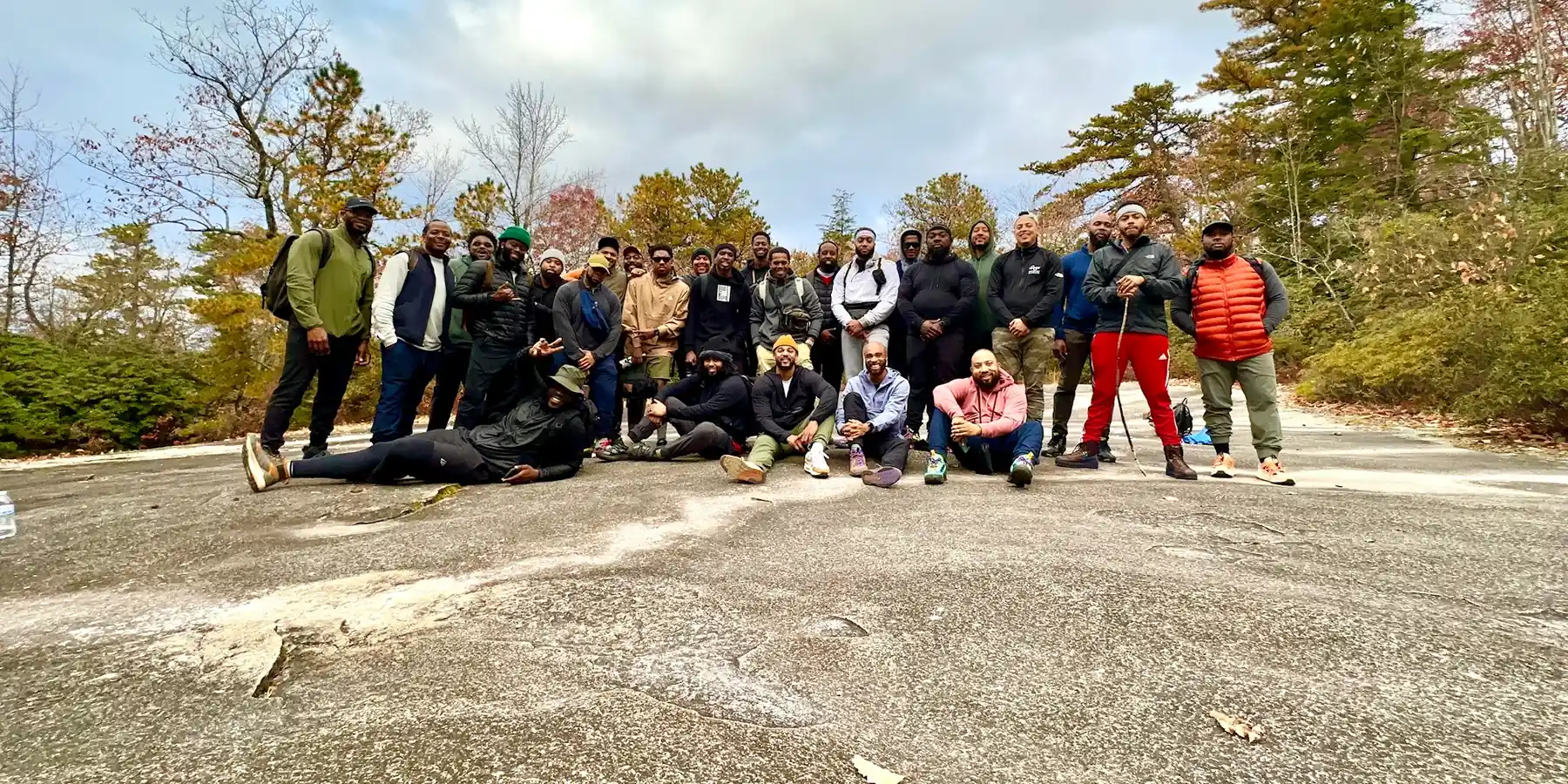The men of The Healing gathered on a summit after a group hike