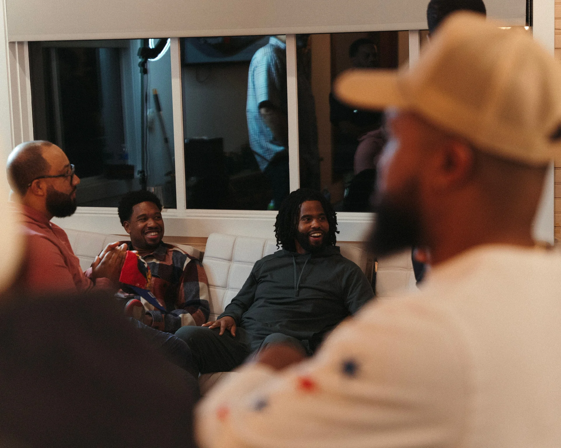 Men of The Healing talking and laughing together indoors