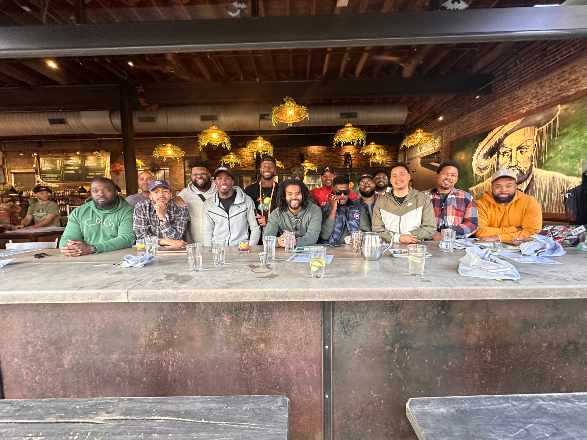 The men of The Healing gathered along a long bar
